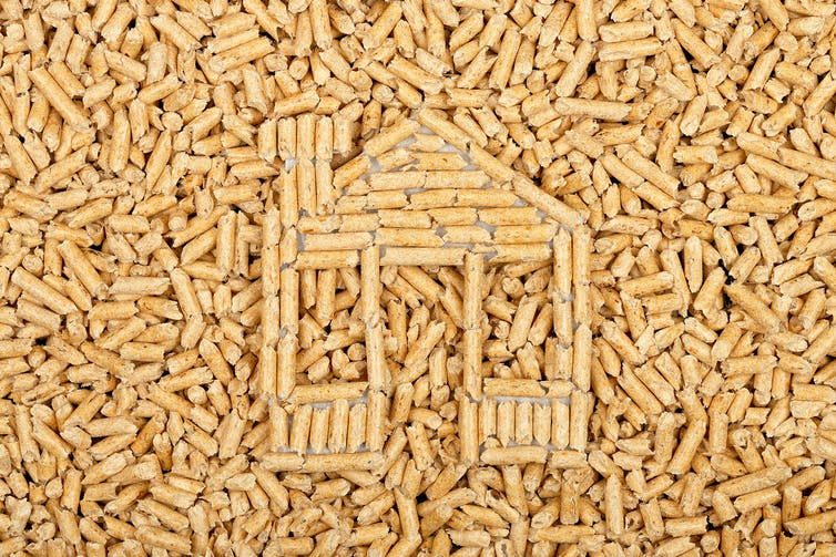Wood pellets in the shape of a house on wood pellets surface